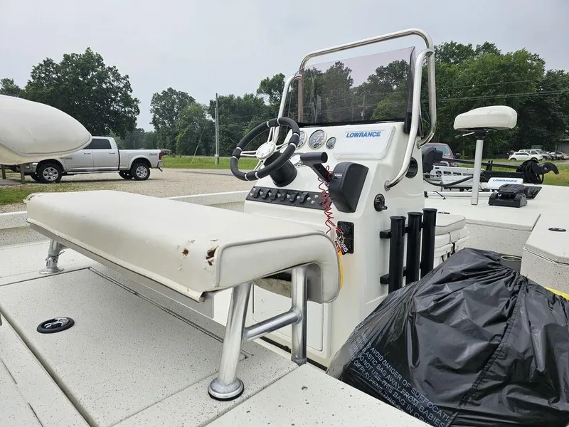 Slide: The Image of 2020 Ranger RB 190 boat with steering console and seating, parked outdoors. - 4