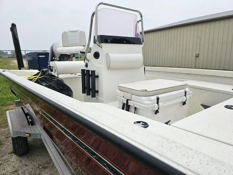 Slide: The Image of 2020 Ranger RB 190 boat with console and seating, parked on a trailer near a building. - 8