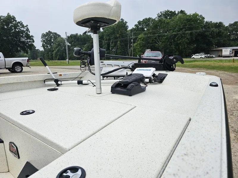 Slide: The Image of 2020 Ranger RB 190 boat with fishing equipment, parked outdoors near trucks and trees. - 9