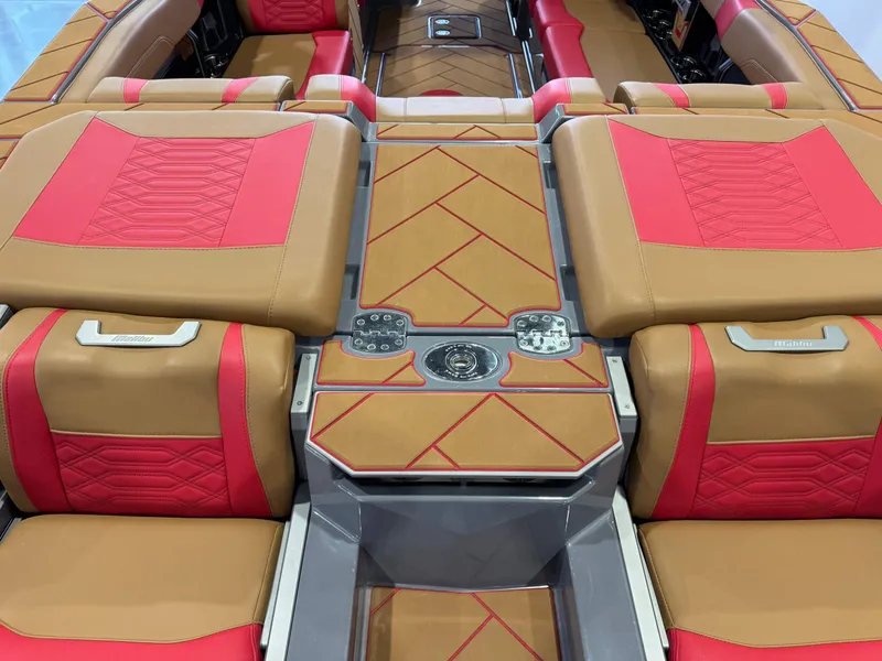 Slide: The Image of 2023 Malibu Wakesetter 26 LSV interior with tan and red upholstery, featuring sleek design and controls. - 10