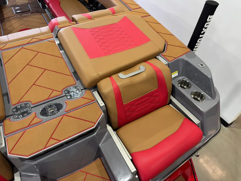 Slide: The Image of 2023 Malibu Wakesetter 26 LSV interior with red and tan seating, cup holders, and stylish design. - 11