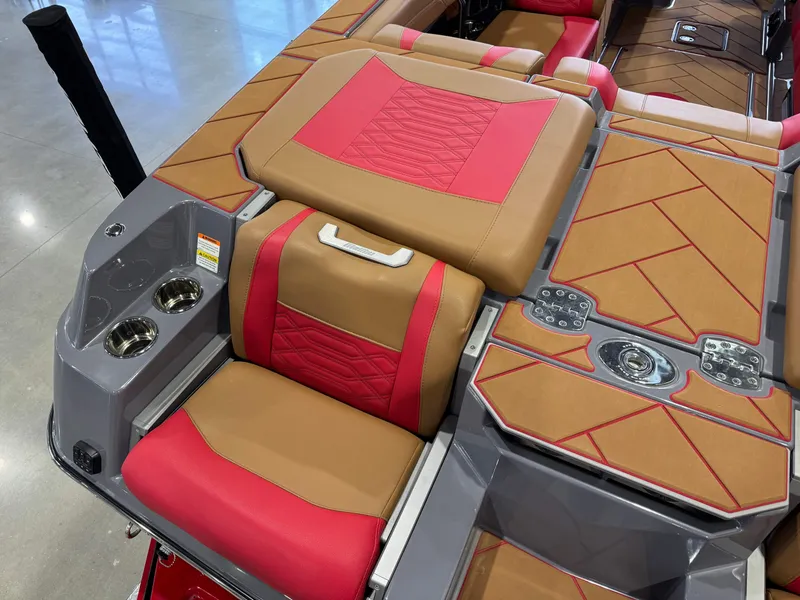 Slide: The Image of 2023 Malibu Wakesetter 26 LSV interior with red and tan seating, cup holders, and stylish design. - 12