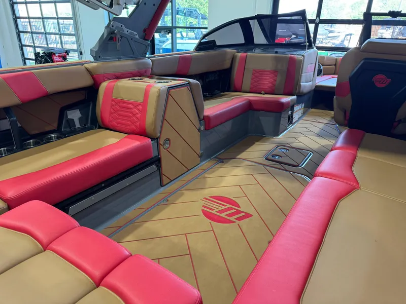 Slide: The Image of 2023 Malibu Wakesetter 26 LSV interior with red and tan seating, showcasing luxury design. - 14