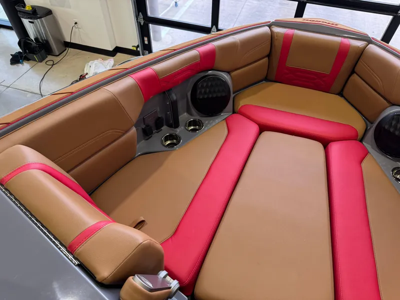 Slide: The Image of 2023 Malibu Wakesetter 26 LSV interior with red and brown seating, cup holders, and speakers. - 19