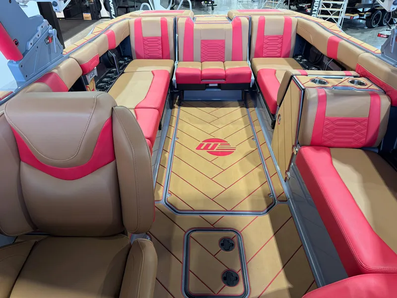 Slide: The Image of 2023 Malibu Wakesetter 26 LSV interior with red and tan seating, luxurious design. - 22