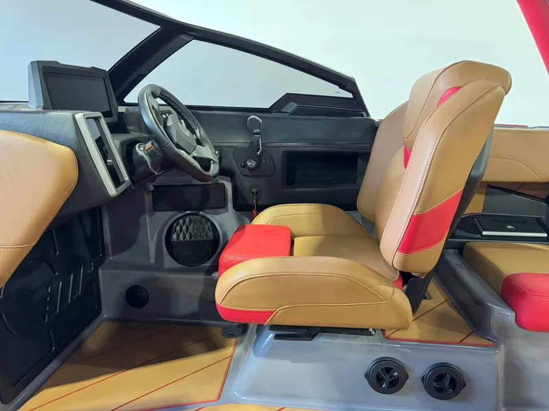 Slide: The Image of 2023 Malibu Wakesetter 26 LSV interior with tan and red seating, modern dashboard. - 23