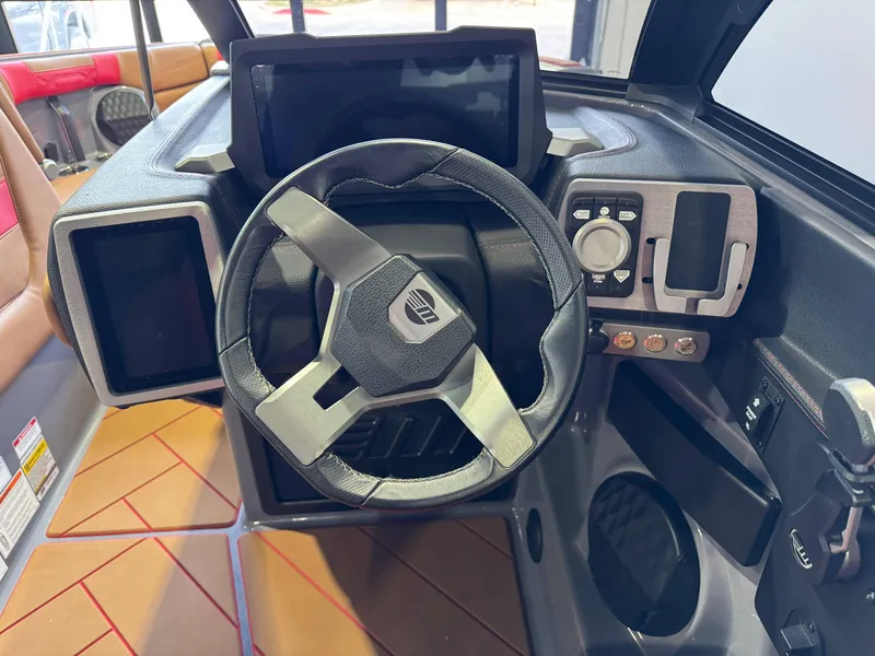 Slide: The Image of 2023 Malibu Wakesetter 26 LSV dashboard with steering wheel and digital controls. - 26