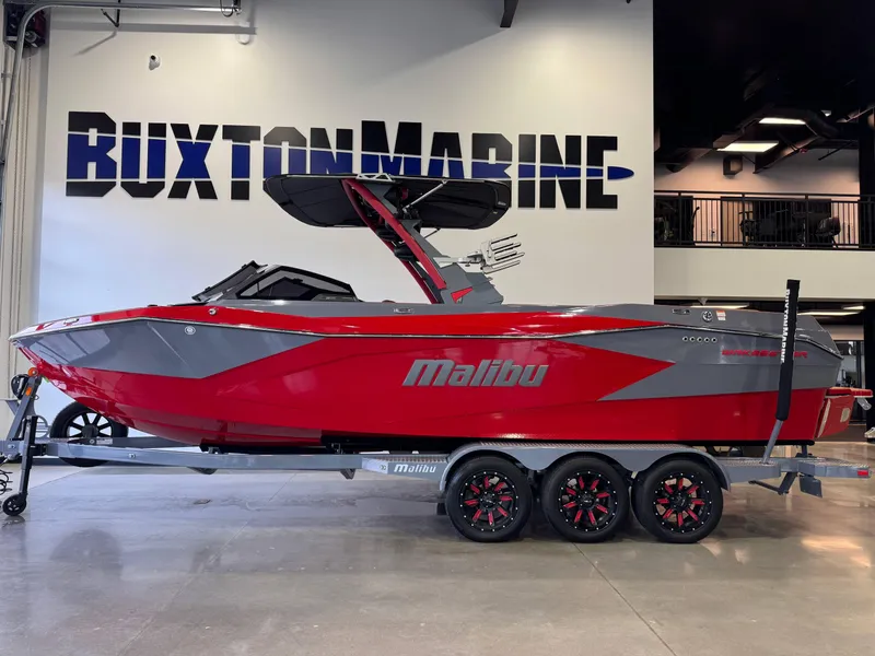 Slide: The Image of 2023 Malibu Wakesetter 26 LSV boat in red and gray on a trailer at Buxton Marine. - 4