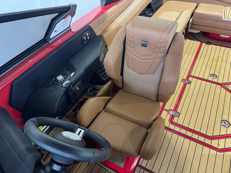 Slide: The Image of 2024 Nautique Super Air Nautique G25 interior with tan seating and modern dashboard. - 20