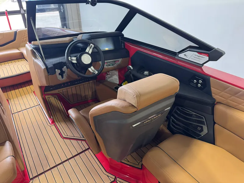 Slide: The Image of 2024 Nautique Super Air Nautique G25 interior with tan seats and modern dashboard. - 23