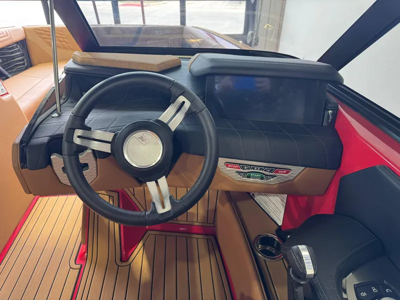 Slide: The Image of 2024 Nautique Super Air Nautique G25 dashboard with steering wheel and control panel. - 25