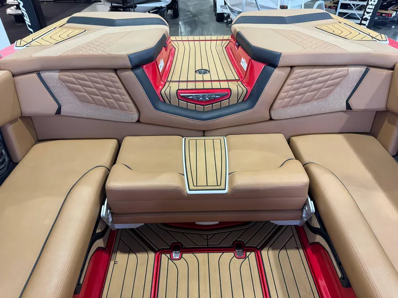 Slide: The Image of 2024 Nautique Super Air Nautique G25 interior with tan upholstery and red accents. - 26