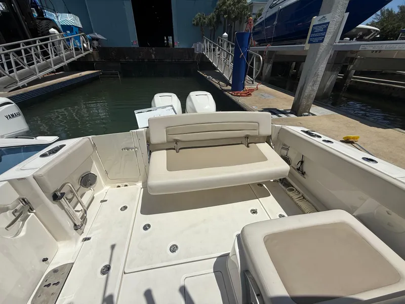 Slide: The Image of 2017 Boston Whaler 320 Vantage boat interior with seating and dock view. - 10