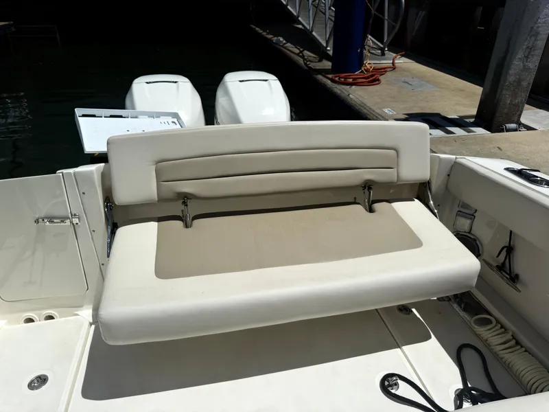 Slide: The Image of 2017 Boston Whaler 320 Vantage boat with foldable seating at the stern. - 11