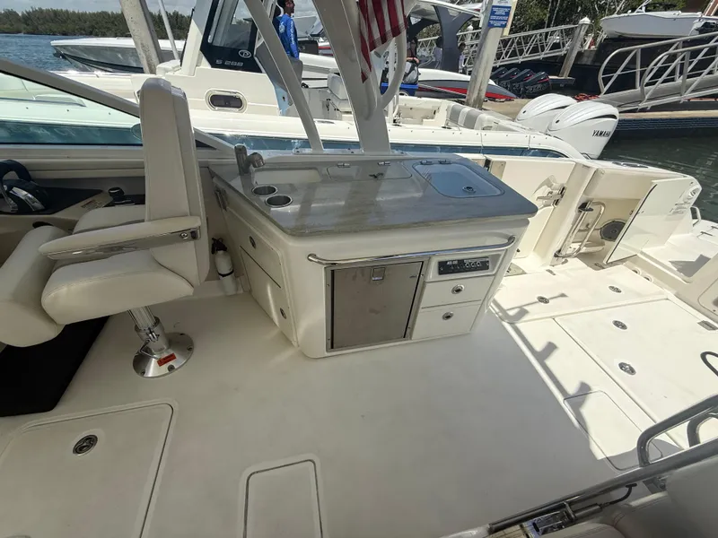Slide: The Image of 2017 Boston Whaler 320 Vantage boat interior with seating and storage. - 13
