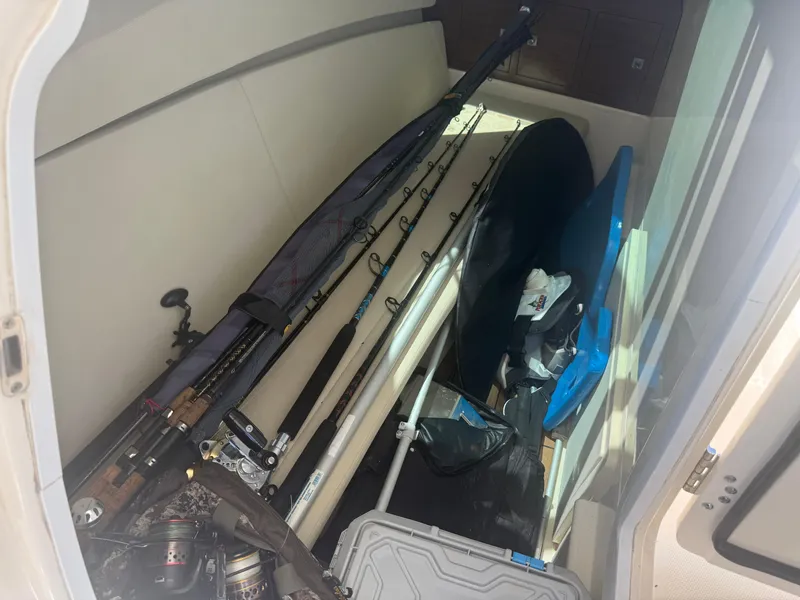 Slide: The Image of Storage compartment of a 2017 Boston Whaler 320 Vantage with fishing gear and equipment. - 16