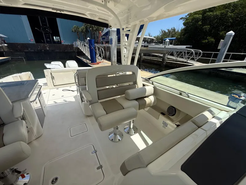Slide: The Image of 2017 Boston Whaler 320 Vantage boat interior with seating and dock view. - 17