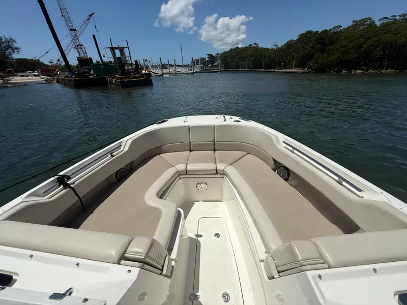 Slide: The Image of 2017 Boston Whaler 320 Vantage boat with spacious seating, docked in a serene marina. - 20