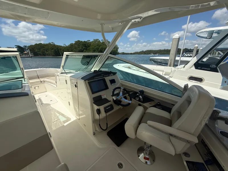 Slide: The Image of 2017 Boston Whaler 320 Vantage boat interior with helm, steering wheel, and seating. - 4