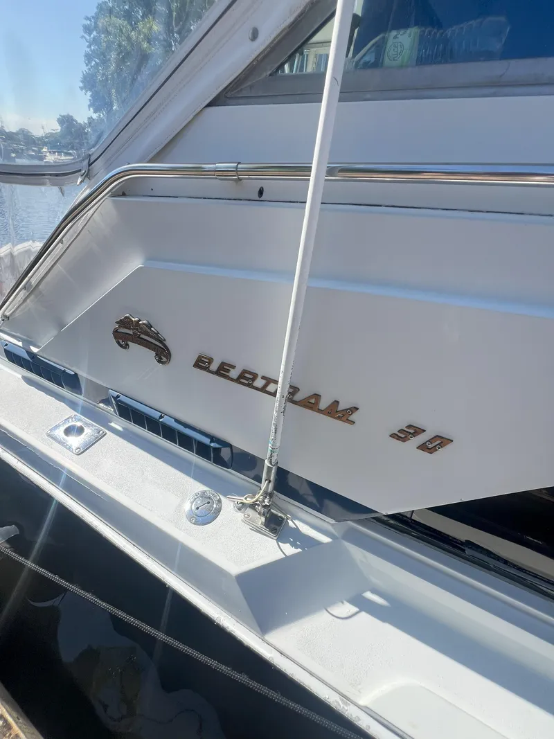 Slide: The Image of 1984 Bertram 30 Express boat with sleek design and chrome accents. - 10