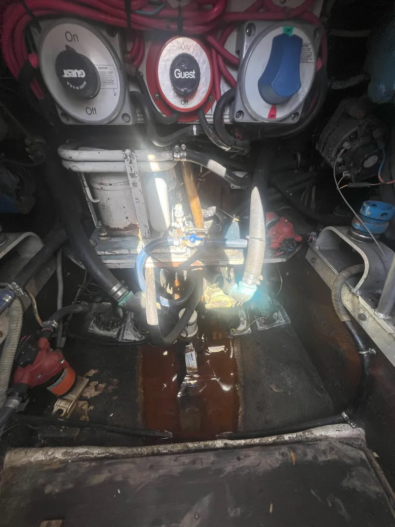 Slide: The Image of Engine compartment of a 1984 Bertram 30 Express boat, showing wiring and mechanical components. - 15