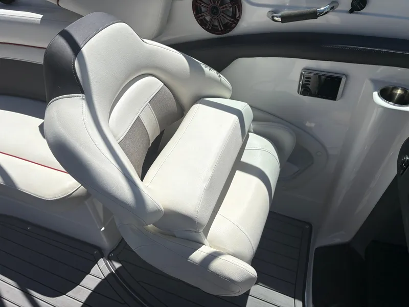 Slide: The Image of 2018 Rinker 26QX BR boat interior with cushioned seating and modern design. - 15