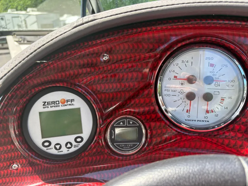 Slide: The Image of Dashboard of 2018 Rinker 26QX BR boat with gauges and controls. - 18