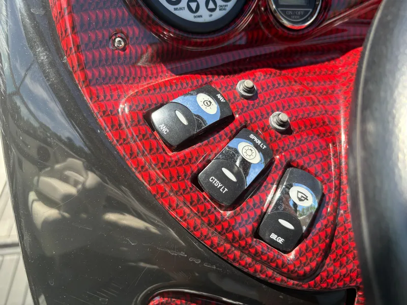 Slide: The Image of Control panel of 2018 Rinker 26QX BR boat with red carbon fiber finish. - 20