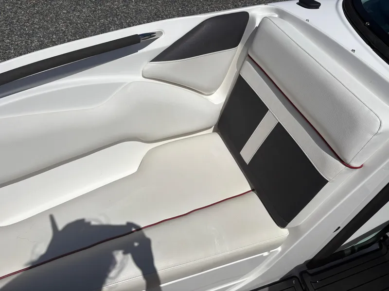 Slide: The Image of 2018 Rinker 26QX BR boat interior with white and black seating. - 30