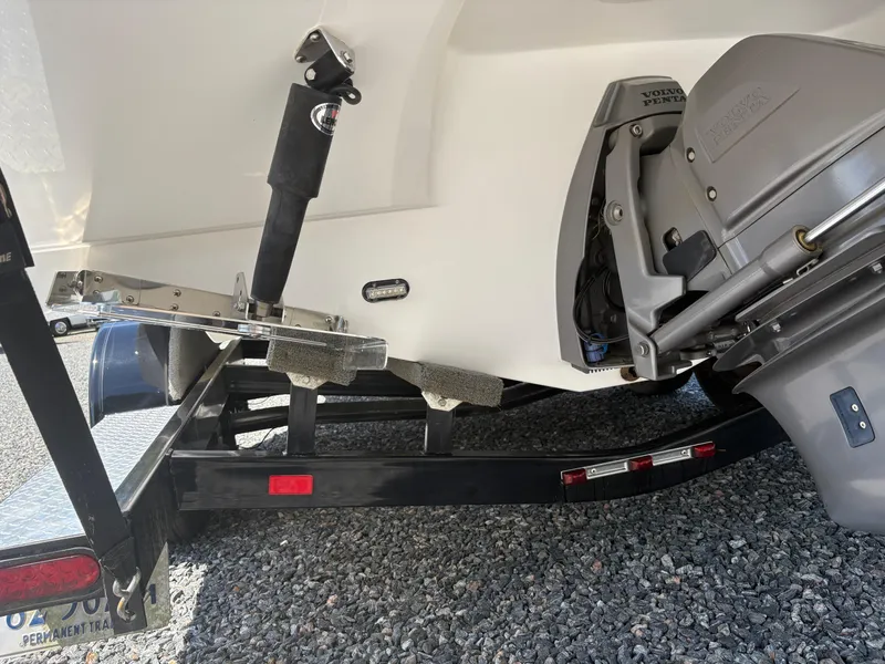 Slide: The Image of 2018 Rinker 26QX BR boat on trailer, featuring Volvo Penta outdrive. - 8