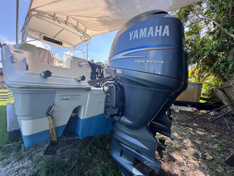 Slide: The Image of 2011 Sea Fox 256 WA Voyager with Yamaha four-stroke outboard engine, parked outdoors. - 11