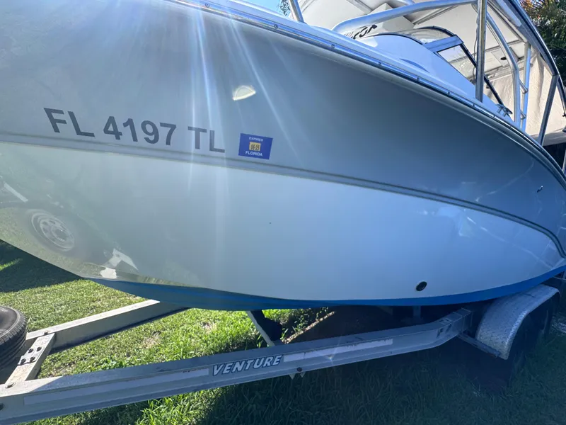 Slide: The Image of 2011 Sea Fox 256 WA Voyager boat on trailer, sunlight reflecting on hull. - 17