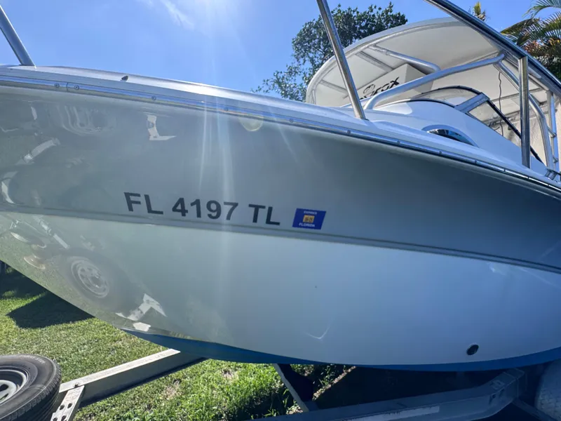 Slide: The Image of 2011 Sea Fox 256 WA Voyager boat on trailer, Florida registration visible. - 18