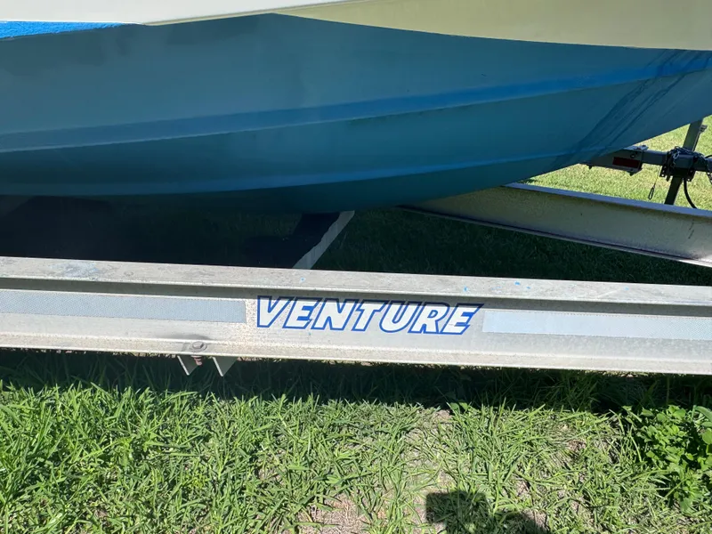 Slide: The Image of 2011 Sea Fox 256 WA Voyager on Venture trailer, parked on grass. - 24