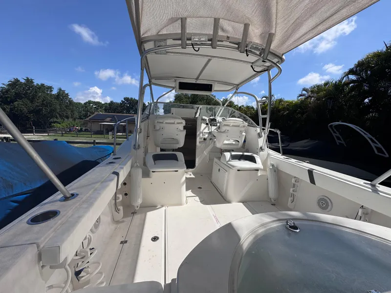 Slide: The Image of 2011 Sea Fox 256 WA Voyager boat interior with seating and canopy under blue sky. - 39