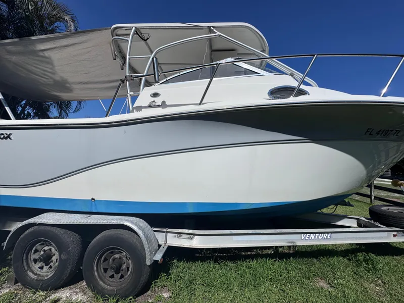 Slide: The Image of 2011 Sea Fox 256 WA Voyager boat on trailer under clear blue sky. - 4
