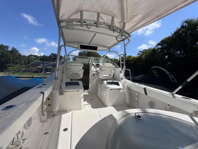 Slide: The Image of 2011 Sea Fox 256 WA Voyager boat interior with seating and canopy under blue sky. - 40