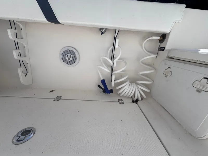 Slide: The Image of 2011 Sea Fox 256 WA Voyager boat interior with coiled hose and speaker. - 42