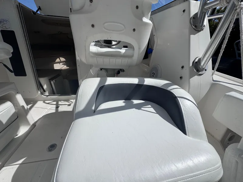 Slide: The Image of 2011 Sea Fox 256 WA Voyager boat interior with white seating and cabin entrance. - 47