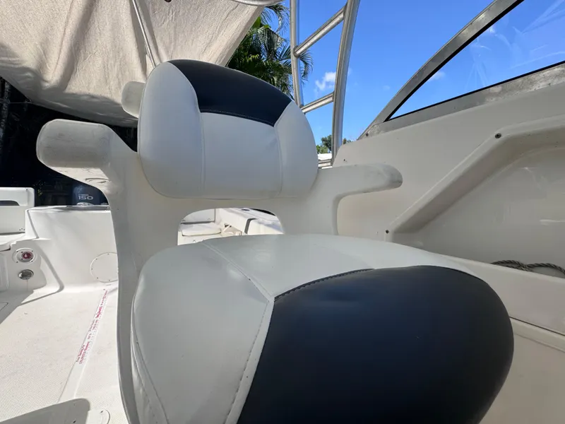 Slide: The Image of 2011 Sea Fox 256 WA Voyager boat seat, white and black upholstery, sunny day. - 49
