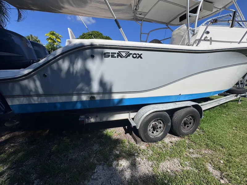 Slide: The Image of 2011 Sea Fox 256 WA Voyager boat on trailer, side view under canopy. - 7