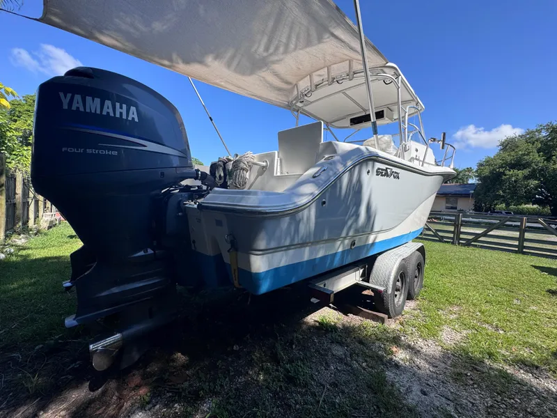 Slide: The Image of 2011 Sea Fox 256 WA Voyager boat with Yamaha engine on trailer, under canopy. - 9