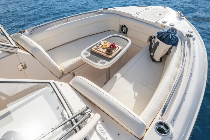 Slide: The Image of 2026 Grady-White Freedom 275 boat interior with canopy and seating, under clear blue sky. - 10