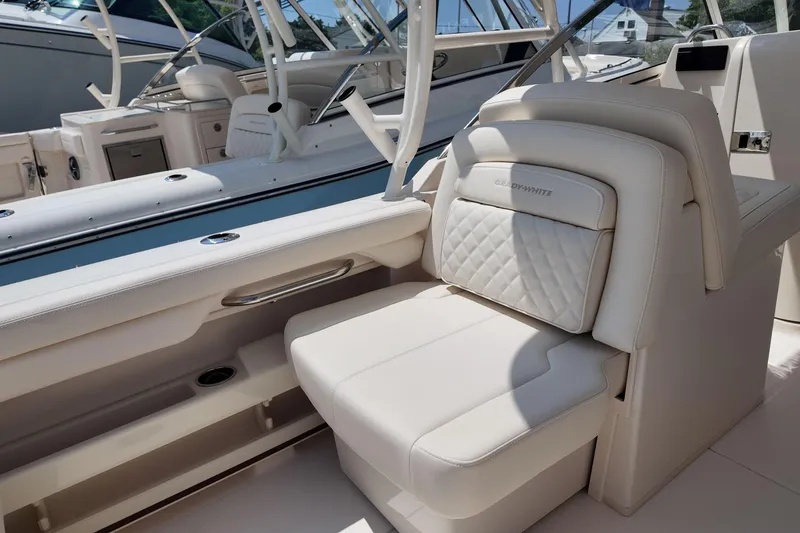Slide: The Image of 2026 Grady-White Freedom 275 boat interior with luxurious white seating. - 13