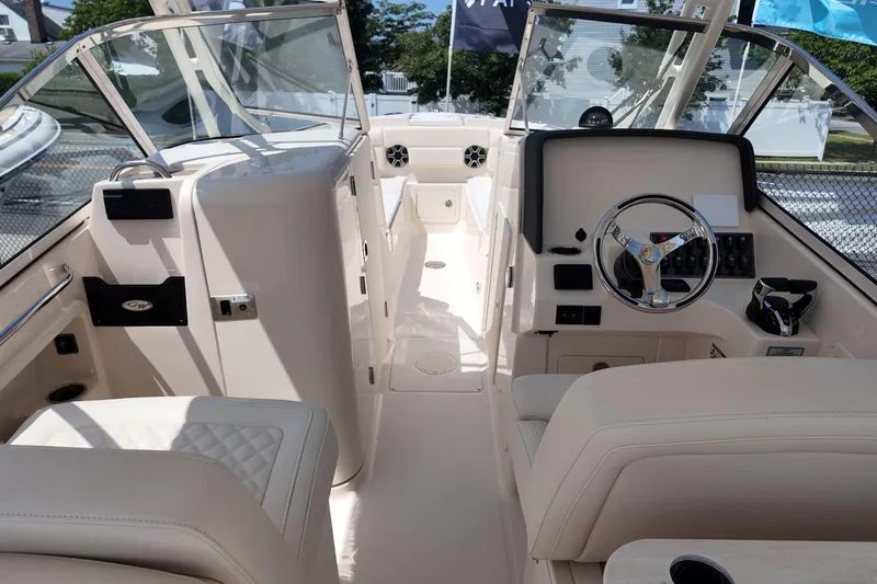Slide: The Image of 2026 Grady-White Freedom 275 boat interior with steering wheel and seating. - 14