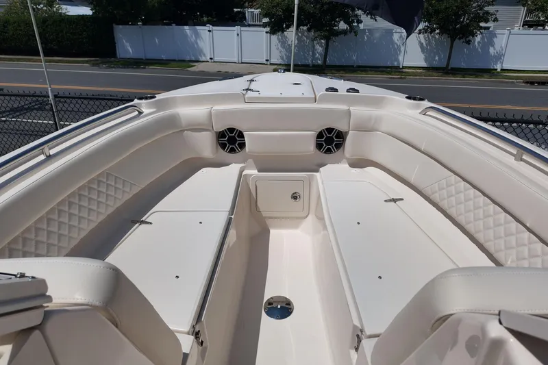 Slide: The Image of 2026 Grady-White Freedom 275 boat interior with cushioned seating and storage compartments. - 20