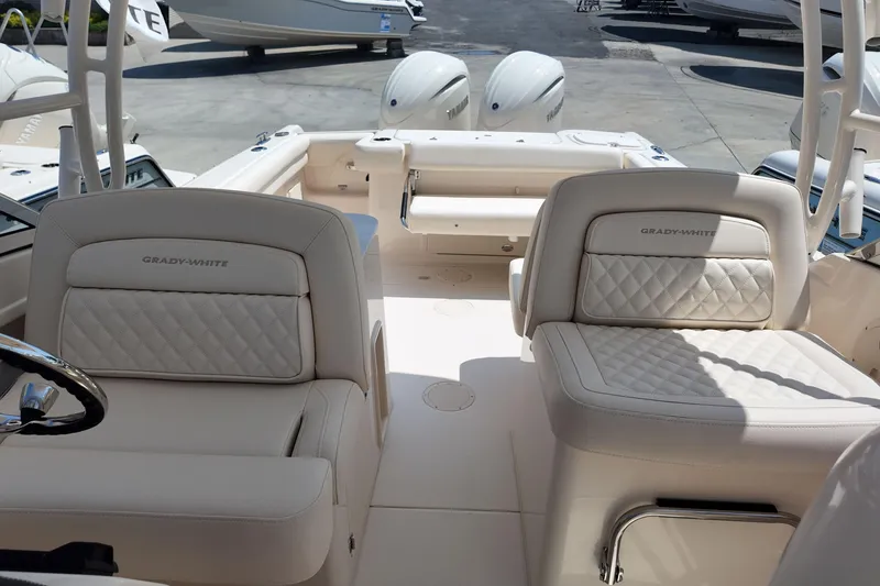Slide: The Image of 2026 Grady-White Freedom 275 boat interior with luxurious seating and dual engines. - 24