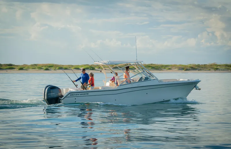 Slide: The Image of 2026 Grady-White Freedom 275 boat with twin Yamaha 200 engines, docked outdoors. - 3