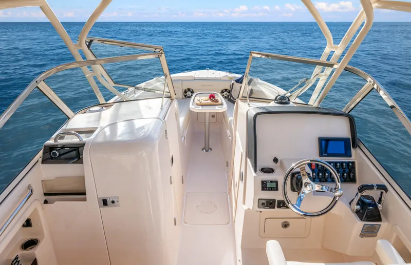 Slide: The Image of 2026 Grady-White Freedom 275 boat interior with Yamaha engines, featuring a foldable seat. - 6