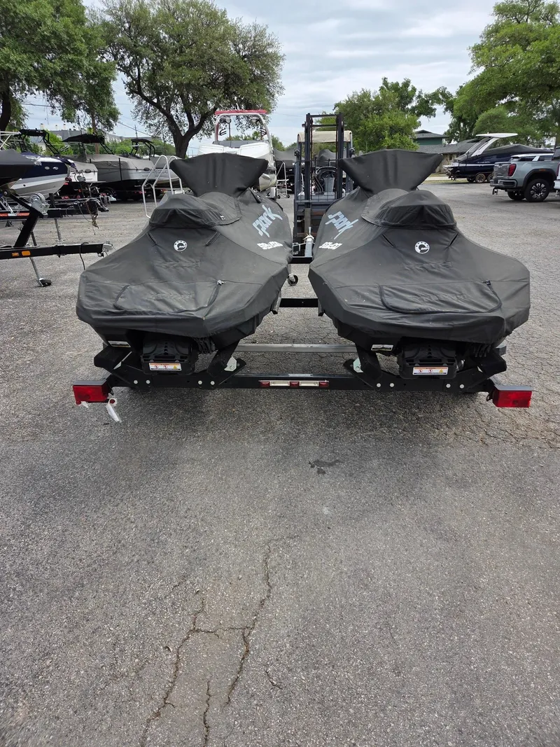 Slide: The Image of Two covered 2021 Sea-Doo Spark 2up jet skis on a trailer in a parking lot. - 4